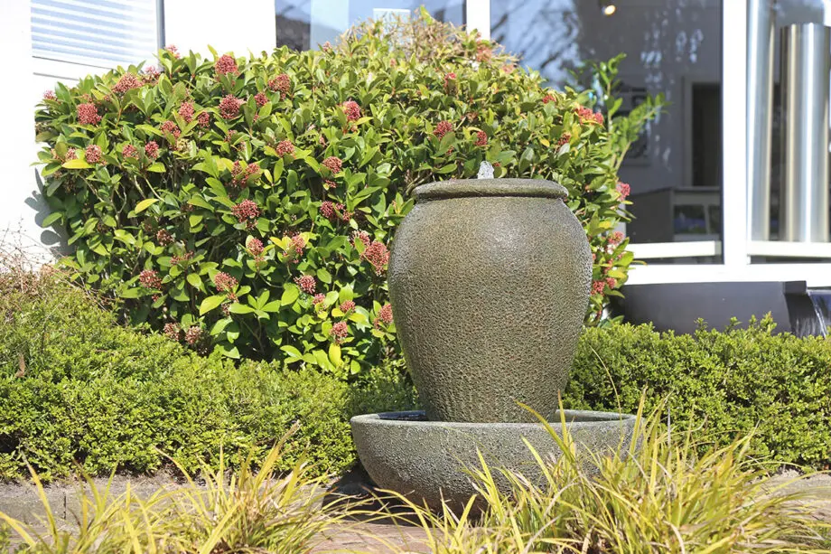 Palermo Keramik-Springbrunnen mit Schale in antiker Krugform, Wasser fließt in die Schale, aufgestellt auf einer Terrasse mit roten Pflastersteinen.